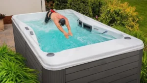 Picture of a person using a swim spa for the blog about hot tubs vs. swim spas.