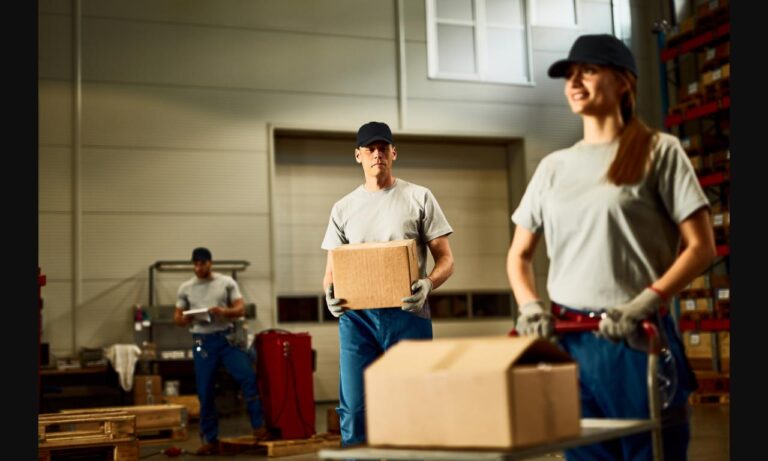 i ibb co 0MDkD3b mid adult worker carrying cardboard box while working with colleagues industrial warehouse jpg 768x461