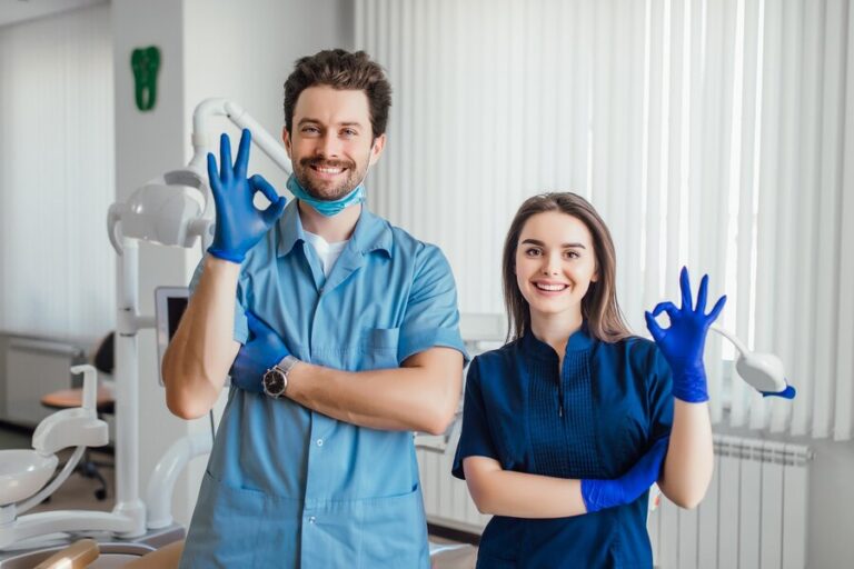 photo smiling dentist standing with arms crossed with her colleague showing okay sign 496169 1043 768x512